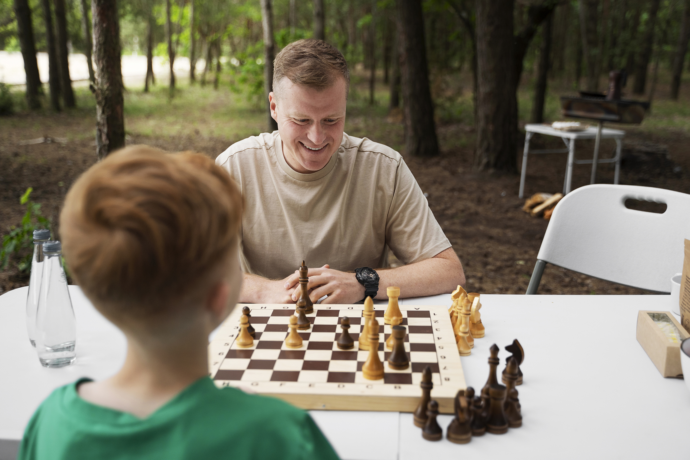 Medium shot kid father playing chess